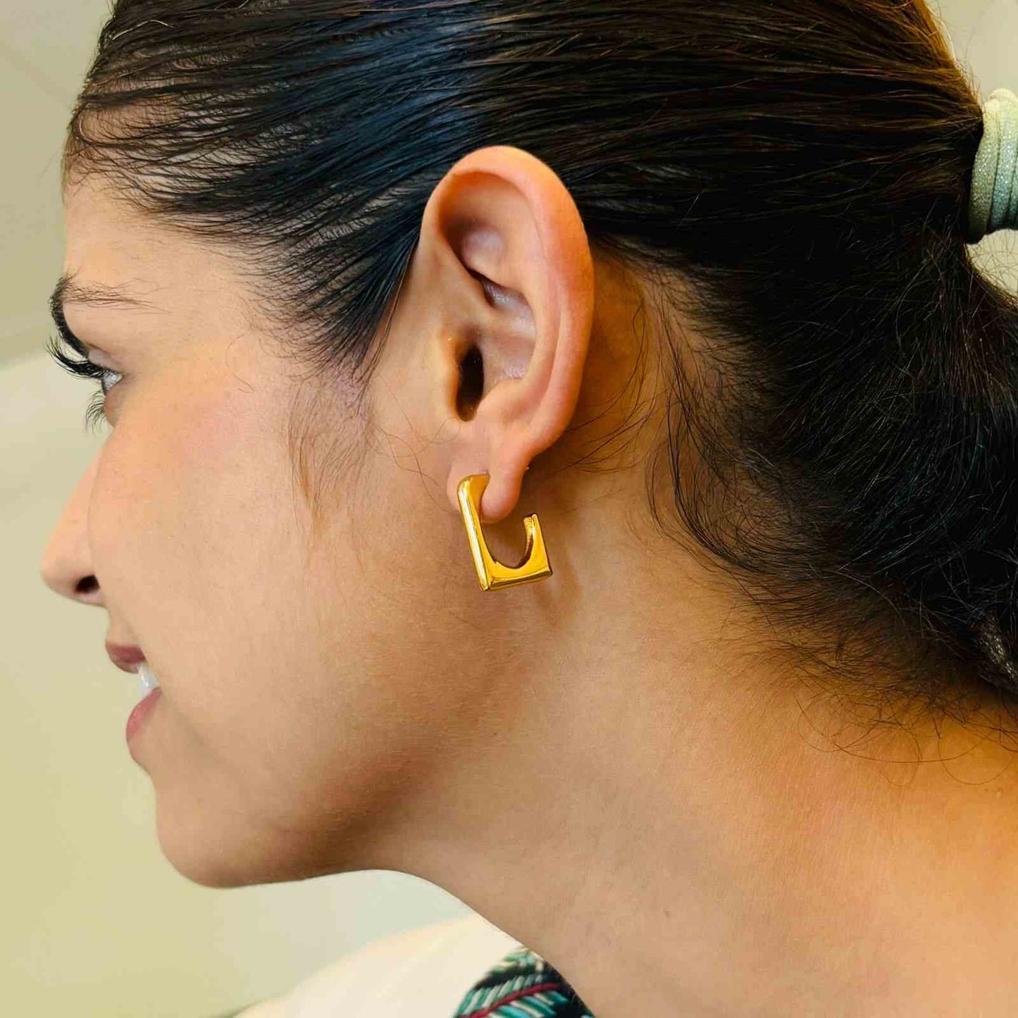 Gold Ear Studs On Contemporary Shape